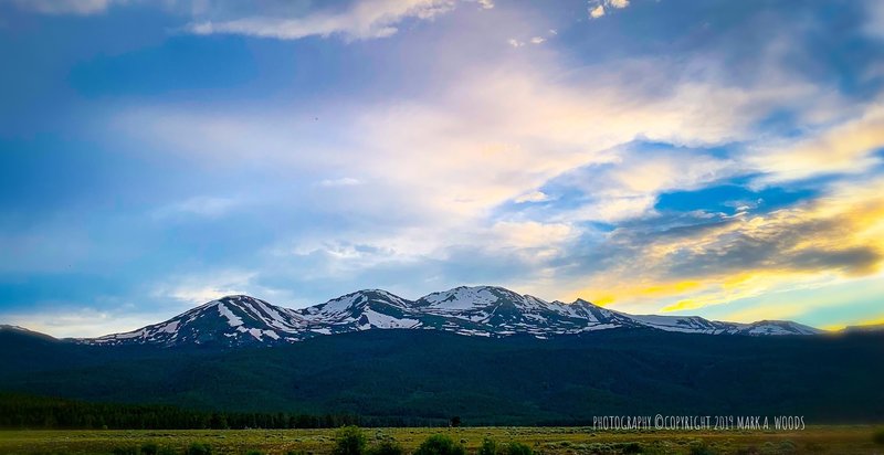 Mount Massive, 2ND highest Colorado 14er, still snow capped, second week of July 2019. View looking west from Halfmoon Road after climbing Mount Elbert earlier this day. Mount Massive at #2 ranked is only 6 feet lower than Mount Elbert.