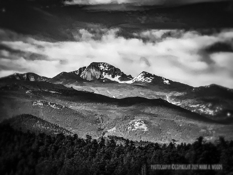 View of Longs Peak, highest point in Rocky Mountain National Park, elevation 14,255 feet. Fifteenth highest Colorado 14er. July 12, 2019 and still snow capped above 12,000 feet.