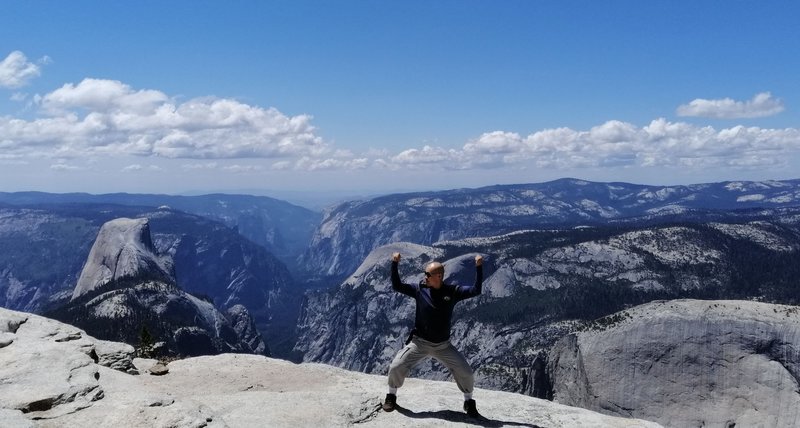 At the peak of Clouds Rest with the "Inverse Tunnel View" of the Yosemite Valley in the background. he out-and-back hike to Clouds Rest from Tenaya Lake is one of the most rewarding one in Yosemite.