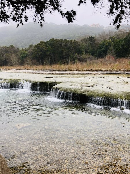 Low waterfalls and a shallow creek are great for dogs to play. Water level can drop significantly in summer.