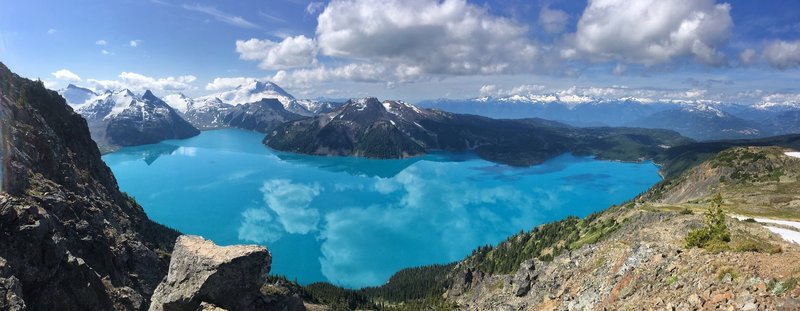 View of Garibaldi Lake from Panorama Ridge Trail. Taken around 10am, no wind and reflection of skies on the still lake