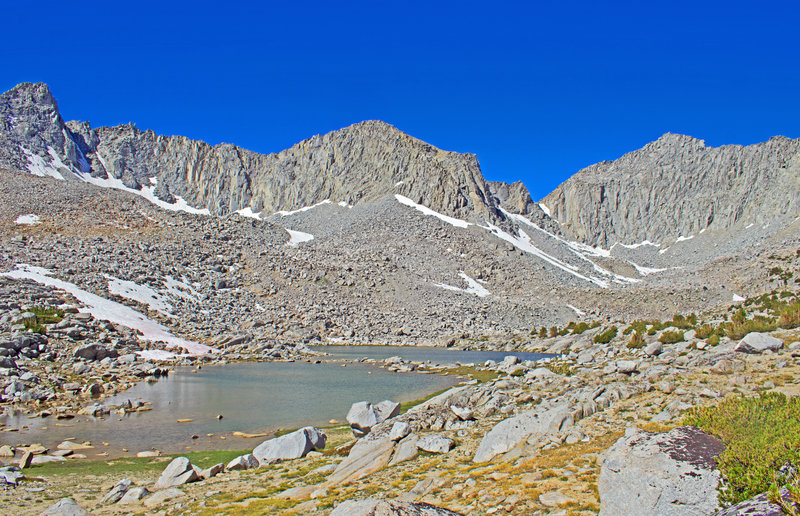 At 11,200 feet, this is the highest of the lakes in Pioneer Basin. It is a large lake that extends behind the very low ridge on the right side.