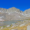 At 11,200 feet, this is the highest of the lakes in Pioneer Basin. It is a large lake that extends behind the very low ridge on the right side.