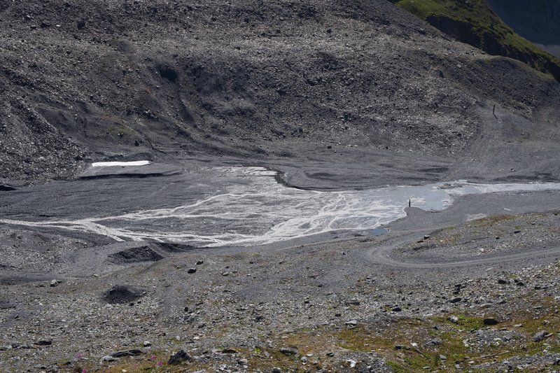 View down into the Glacier Bowl in the summer as snow melts and feeds a creek that runs down the mountain.