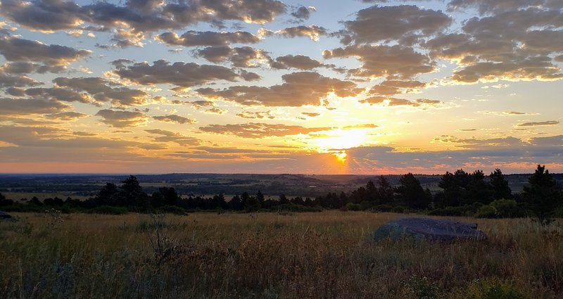 Just after sunrise on a partly cloud morning, along the Lower Big Bluestem trail near the intersection with the Mesa Trail.