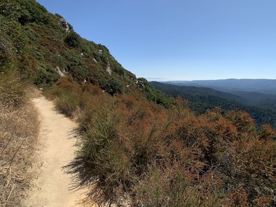 Sunny and surprisingly windless afternoon on a dusty, one-lane trail. Looking south-southeast.