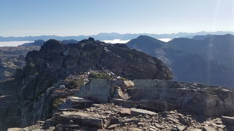 Summit of Scotchman Peak with a mountain goat left-middle.