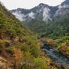 View of the gently flowing Rogue River from the elevated trail on the western shore.