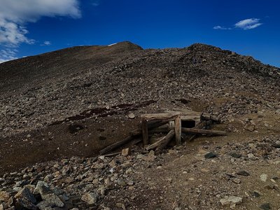 Turn left at the saddle between Mount Democrat & Cameron. Silver was first discovered here in ca. 1874. Abandoned mines are a regular feature. Stay on the marked Trail!
