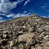 Above the saddle of Mount Cameron, this is your view up towards the false summit of Mount Democrat. Keep going and that snowfield dip down is your way up to the Summit. (Farther than it looks,  closer than it appears). Pay Attention! now to the weather!