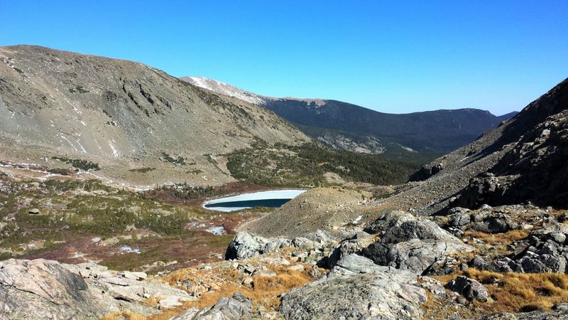 Along the south contours between the two lakes, the higher up you go, the better. Rock/grass rather than rock/willows down below.