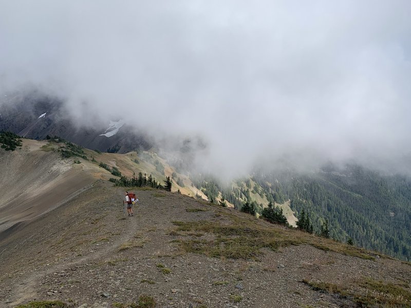 Heading down the ridge from Constance Pass through the clouds.