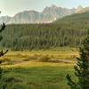 Poboktan Creek is in a meadow below Poboktan Pass Trail and Waterfalls Warden Cabin. Waterfall Peaks are not far away, across the meadow and forested hills.