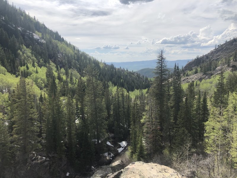 Hike up rocky incline, looking over valley