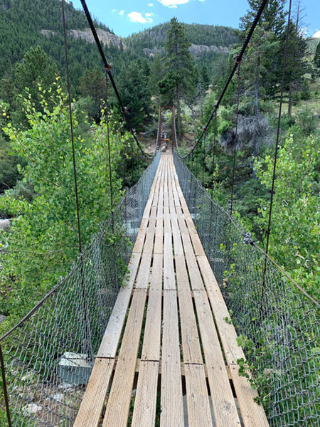 Suspension bridge crossing the Popo Agie at the trailhead