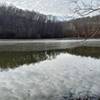 A thin film of ice covers most of the lake on a December morning