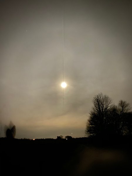 Contrail bisecting Moon on Full Moon Hike Program