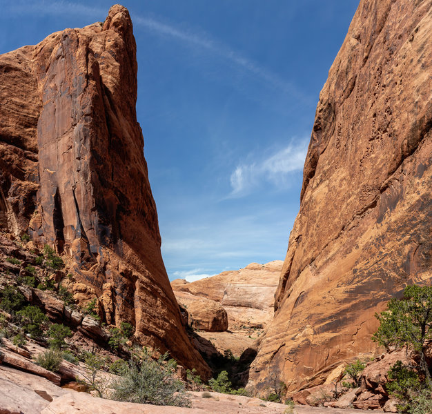 The Breach - a narrow opening between two massive walls. Descend carefully down the steep trail.