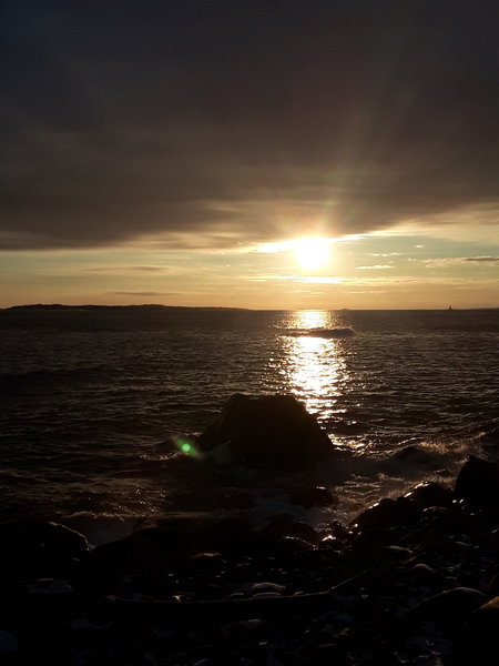 The sun breaks out from the clouds over Fisher's Island Sound