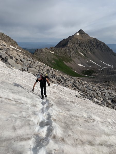 Crossing a snow field just past the saddle on the way to Capitol Peak.