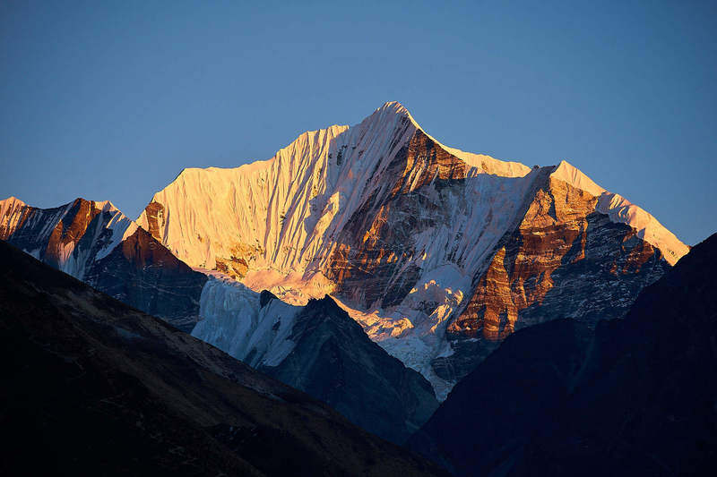 Mount Gangchenpo (6,387 meters / 20,955 feet) as seen from Langtang Village at dusk.