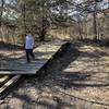 This section floods and the bridge has been here at least 15 years...its floated off it's original location and fallen apart a bit...but still can get you across the mudhole when you need it!