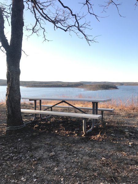 Picnic table by lake on orange trail about 1.5 miles from trailhead; great place to relax