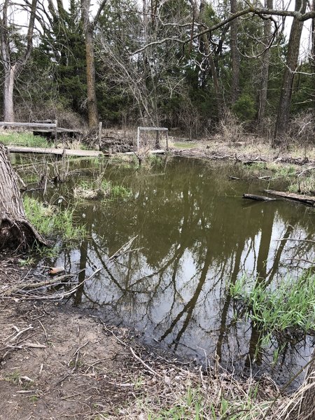 So the trail is flooded and you have to go around...several of the satellite photos seems to show this as dry, so maybe it is passable in the summer.  Your mileage may vary.