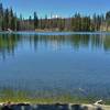 Lassen Peak in the distance to the west, is seen across Rainbow Lake close to Rainbow Lake Trail.