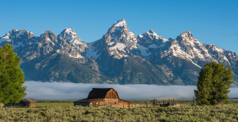 Moulton Barn on Mormon Row with the Grand Tetons, and an early morning fog.