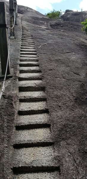 Ancient stairs carved into the rock leading to the dagaba at the top of the mountain.