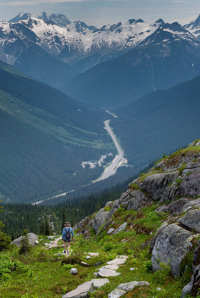 A hiker descends the Hermit Trail towards the Roger's Pass.