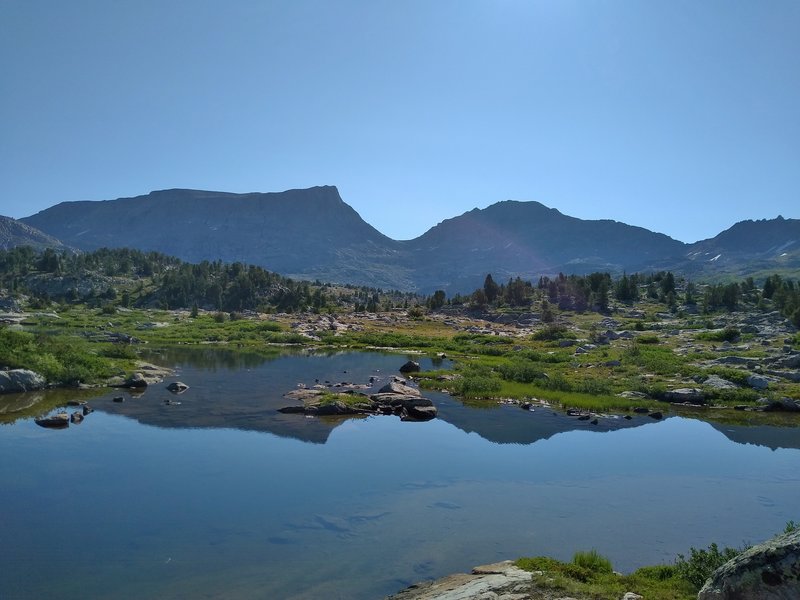 Angel Pass, at 11,600+ ft is the pass in the center, between Angel Peak, 12,402 ft. to the left, and an unamed peak, 12,367 ft. to the right.  All are on the Continental Divide. Taken from the CDT/Fremont Trail in Bald Mountain Basin, west of the Divide.