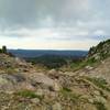 Under threatening skies, rugged foothills emerge in the view to the south from Hat Pass, along the CDT/Fremont Trail.