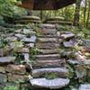 Stone steps leading to a grindstone table picnic area on the Chinqua-Penn Walking Trail.