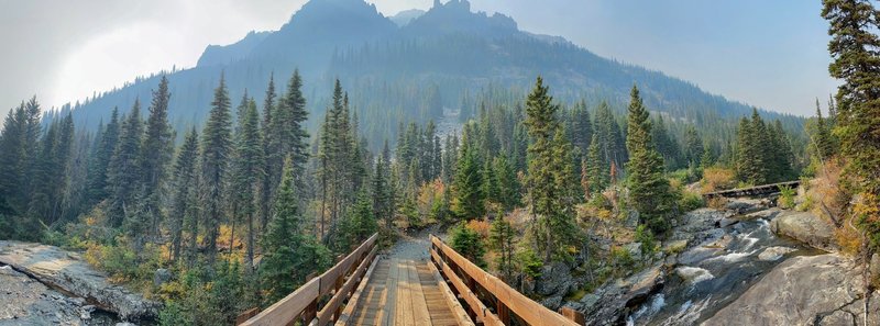 Mountains rising above the creek on a smoky day.