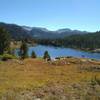 One of many small lakes in the high country, passed by Summit Lake Trail. Rugged peaks of the Wind Rivers are seen in the distance to the east here.