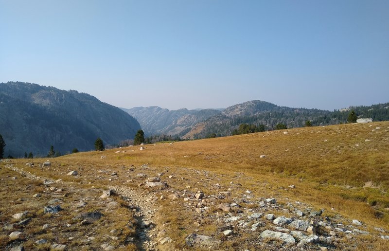 The valley ahead is the start of the Pine Creek drainage, high up here near Summit Lake. Pine Creek and its tributaries eventually flow into Fremont Lake, and on to Pinedale. Looking south from the CDT near Summit Lake on a gorgeous September morning.