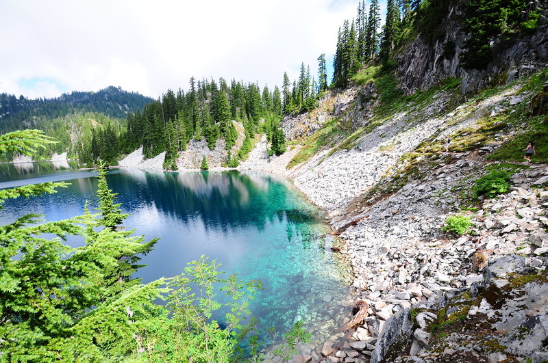 Hikers continue towards the Gem Lake Trail on the upper end of Snow Lake.