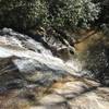 View looking down falls over open slickrock area.