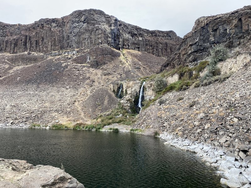 Looking across an Ancient Lake to a a couple waterfalls. You can skirt either side of the lake and pass right under the waterfall if desired!