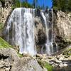 Dunanda Falls on Boundary Creek. There are several hot springs that trickle down the canyon walls near the bottom of the falls which make perfectly warm pools to relax in. The warm spring water and the cool mist from the falls combine perfectly.