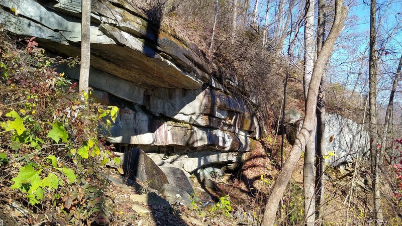 Trail passing under rocky outcrop. Water will be falling over top during periods of wet weather.