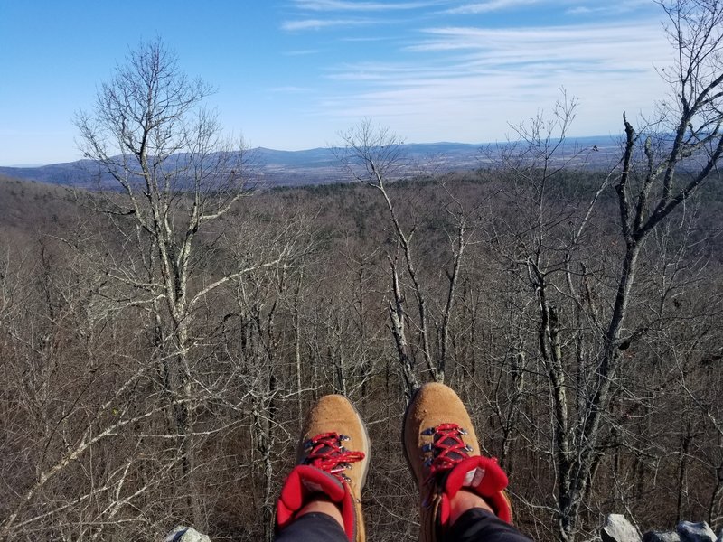 Sitting atop the rock outcrop at Mena Peak.