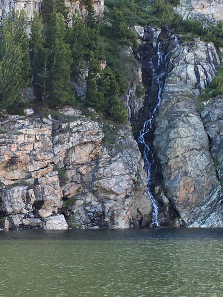 Looking over Jack Joe lake to stream going down face of rocks.