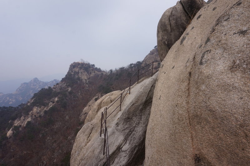 Bukhansan Traverse below Munsubong Peak, at this point I lost my footing on the ice covered rock but I did make a grab for the wire rope while my legs disappeared over the ledge.