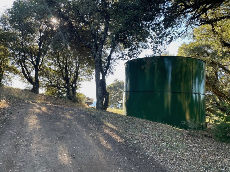 The trail climbs steeply up the hill past this water tower before turning to the left.