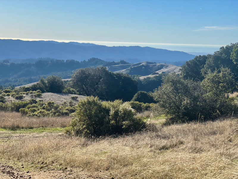 A views of the Santa Cruz Mountains and the Pacific Ocean off in the distance.