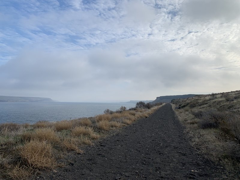 Trail is near water and beautiful plateaus.