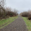 Mostly gravel but some grass areas, restrooms located in a few areas of the trail.